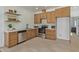 Small kitchen with wood cabinets and stainless steel appliances at 22474 S 199Th Cir, Queen Creek, AZ 85142
