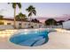 Freeform swimming pool with a spacious patio and lush landscaping at 22474 S 199Th Cir, Queen Creek, AZ 85142