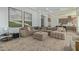 Spacious living area with sectional sofa, large artwork, and views into the kitchen at 22474 S 199Th Cir, Queen Creek, AZ 85142