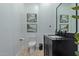 Stylish powder room with black vanity and herringbone tile floor at 22474 S 199Th Cir, Queen Creek, AZ 85142