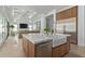 Modern kitchen features a large island with a farmhouse sink and stainless steel appliances at 22474 S 199Th Cir, Queen Creek, AZ 85142