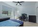 Bedroom with double bed, desk, and large window at 22474 S 199Th Cir, Queen Creek, AZ 85142