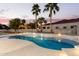 Freeform pool with surrounding patio and palm trees at 22474 S 199Th Cir, Queen Creek, AZ 85142