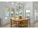 Bright dining area with a round wooden table and four chairs, overlooking the backyard at 22474 S 199Th Cir, Queen Creek, AZ 85142