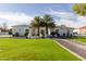 Spacious front yard with palm trees and a stone pathway leading to the entrance at 22474 S 199Th Cir, Queen Creek, AZ 85142