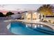 Inviting freeform pool with a large patio and surrounding landscaping at 22474 S 199Th Cir, Queen Creek, AZ 85142