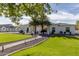 Large front yard with lush green grass and a paved pathway at 22474 S 199Th Cir, Queen Creek, AZ 85142