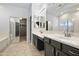 Double vanity bathroom with dark cabinetry and a large mirror at 4512 W Stoneman Dr, Anthem, AZ 85086
