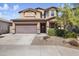 Two-story house with attached garage and landscaping at 4512 W Stoneman Dr, Anthem, AZ 85086