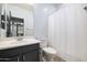 Clean bathroom with dark vanity, toilet, and shower/tub combo at 4512 W Stoneman Dr, Anthem, AZ 85086