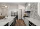 Modern kitchen with stainless steel appliances and white cabinetry at 6429 S Honor Ct, Gilbert, AZ 85298