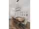 Formal dining room with a large table and statement lighting fixture at 6429 S Honor Ct, Gilbert, AZ 85298