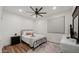 Bright bedroom with a queen-size bed, nightstand, and large window at 6429 S Honor Ct, Gilbert, AZ 85298