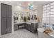 Elegant bathroom with double vanity, soaking tub, and stylish gray cabinets at 6429 S Honor Ct, Gilbert, AZ 85298