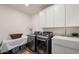 Modern laundry room with white cabinets and new appliances at 6429 S Honor Ct, Gilbert, AZ 85298
