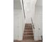 Elegant staircase with wood steps and a modern handrail at 6429 S Honor Ct, Gilbert, AZ 85298
