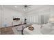 Main bedroom with white plantation shutters, a cozy sitting area and large TV at 6429 S Honor Ct, Gilbert, AZ 85298