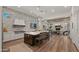 Open concept kitchen with island, stainless steel appliances, and white cabinets at 6429 S Honor Ct, Gilbert, AZ 85298