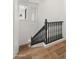 Elegant staircase with dark wood railing and hardwood floors at 6429 S Honor Ct, Gilbert, AZ 85298