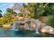 Relaxing pool with a waterfall and rock slide feature at 6429 S Honor Ct, Gilbert, AZ 85298