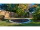 Backyard with trampoline, putting green, and mature trees at 6429 S Honor Ct, Gilbert, AZ 85298