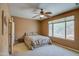 Spacious bedroom with ceiling fan and large window at 697 W Twin Peaks Pkwy, San Tan Valley, AZ 85143