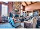 Inviting community library featuring a stone fireplace, comfortable seating, and extensive bookshelves at 697 W Twin Peaks Pkwy, San Tan Valley, AZ 85143