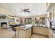 Open kitchen with granite island and views of living room and outdoors at 16349 E Links Dr, Fountain Hills, AZ 85268