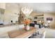 Elegant dining area with a large chandelier and modern table and chairs at 16349 E Links Dr, Fountain Hills, AZ 85268