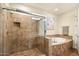 Bathroom with shower and separate tub, neutral tile throughout at 16349 E Links Dr, Fountain Hills, AZ 85268