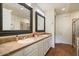 Double vanity bathroom with neutral tile and large mirrors at 16349 E Links Dr, Fountain Hills, AZ 85268