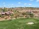 Aerial view of community with multiple residential homes near a golf course at 16349 E Links Dr, Fountain Hills, AZ 85268