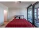 Bedroom with red bedding and access to a balcony at 4808 N 24Th St # 306, Phoenix, AZ 85016