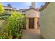 Private backyard entrance with wrought iron gate and landscaping at 3211 E Lavey Ln # 104, Phoenix, AZ 85032
