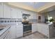 Modern kitchen with white cabinets and tile backsplash at 37206 N Tom Darlington Dr # 6, Carefree, AZ 85377