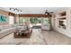 Living room with tiled floor, sliding glass doors, and built-in shelving at 19926 N Organ Pipe Dr, Surprise, AZ 85374