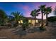 View of backyard at dusk with desert landscaping and palm trees at 19926 N Organ Pipe Dr, Surprise, AZ 85374
