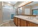 Bathroom with double vanity, large mirror and shower at 19926 N Organ Pipe Dr, Surprise, AZ 85374