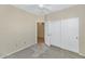 Bedroom with double door closet and access to hallway at 19926 N Organ Pipe Dr, Surprise, AZ 85374