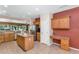 Kitchen with wood cabinets, island, and built-in desk at 19926 N Organ Pipe Dr, Surprise, AZ 85374