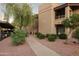Attractive condo building with walkway, landscaping, and parking at 9445 N 94Th Pl # 102, Scottsdale, AZ 85258