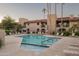 Community pool with surrounding lounge chairs and landscaping at 9445 N 94Th Pl # 102, Scottsdale, AZ 85258