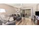 Living room featuring gray sofas, wood floors and access to a patio at 443 S Boojum Way, Mesa, AZ 85208