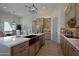 Modern kitchen with light wood cabinets, marble countertops, and a copper farmhouse sink at 1235 E Hohokam Ln, New River, AZ 85087