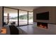 Relaxing main bedroom with fireplace, large windows, and pool views at 6612 E Hummingbird Ln, Paradise Valley, AZ 85253