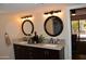 Double vanity bathroom with granite countertops and large mirrors at 8307 E Vista De Valle --, Scottsdale, AZ 85255