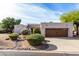 Single-story home with a brown garage door and nicely landscaped front yard at 8307 E Vista De Valle --, Scottsdale, AZ 85255