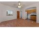 Living room with wood flooring and a view into the kitchen at 35916 N 213Th Dr, Wittmann, AZ 85361