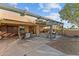 Covered patio with seating area, creating a relaxing outdoor space at 35916 N 213Th Dr, Wittmann, AZ 85361