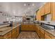 Spacious kitchen with granite countertops and wooden cabinets at 35916 N 213Th Dr, Wittmann, AZ 85361